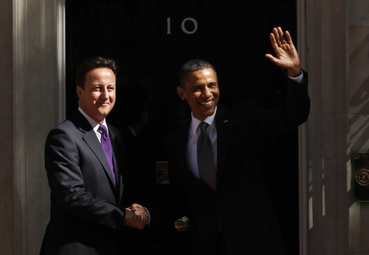 Obama waves as he his greeted by Cameron upon arrival at 10 Downing Street