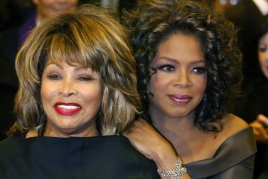 Talkshow host Oprah Winfrey (R) hugs singer Tina Turna