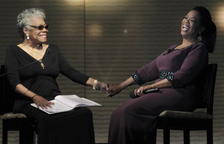 Oprah Winfrey (R) laughs with poet Maya Angelou