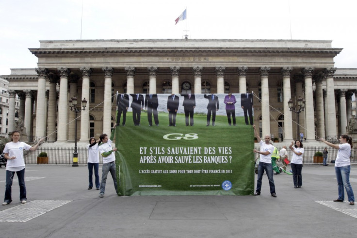 Members of the French doctors group Medecins du Monde hold a banner in front of the former Paris Bourse during an anti-G8 summit protest in Paris