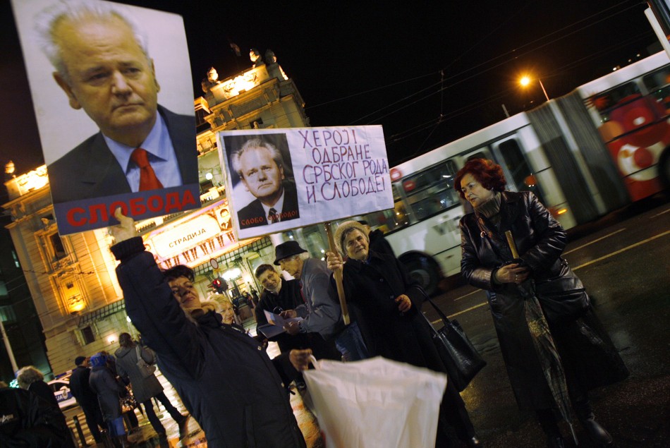 Demonstrators hold placards depicting former Yugoslav President Milosevic during the 10th anniversary of the NATO bombing missions in Yugoslavia, in Belgrade