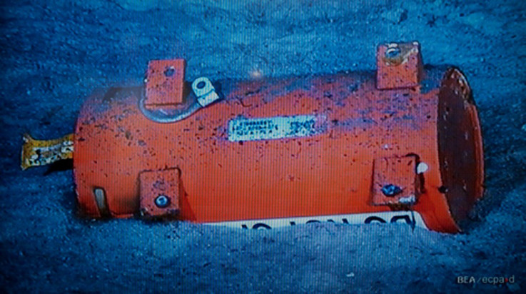 A flight data recorder, seen in this image published on the web site of France&#039;s BEA air accident inquiry office May 1, 2011, show an orange cylindrical object half-buried in sand