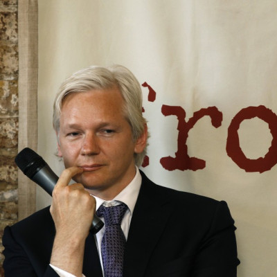 WikiLeaks founder Julian Assange listens during a news conference at the Frontline Club in London