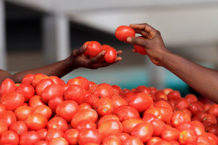 A woman buys tomatoes at Gouro market in Abidjan