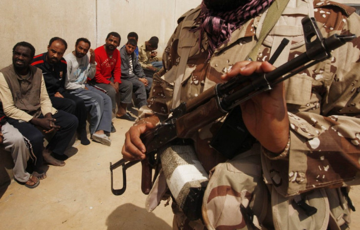 Rebel guards suspected mercenaries and forces loyal to Libyan leader Muammar Gaddafi inside a prison in Benghazi