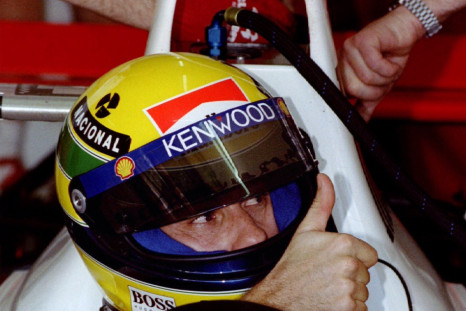 Former World Champion Brazilian Ayrton Senna gives the thumbs up to his pit crew after completing th..