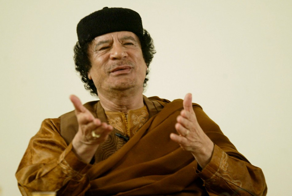 Libyan leader Gaddafi looks on during his debate on democracy with Western scholars in Sebha