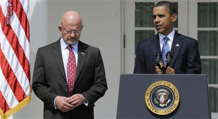 Retired General James Clapper stands next to President Barack Obama in the Rose Garden at the White House in Washington