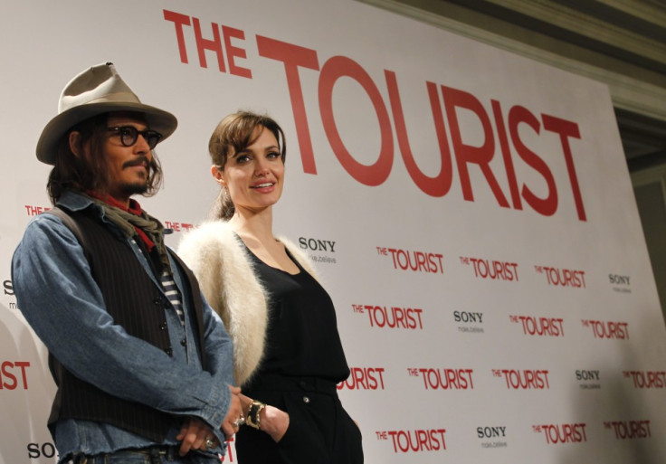 U.S. actors Angelina Jolie (R) and Johnny Depp pose for pictures during a photocall promoting their movie &quot;The Tourist&quot; in Madrid