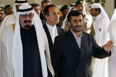 Iran&#039;s President Ahmadinejad walks hand-in-hand with Saudi Arabia King Abdullah as they arrive for the opening of GCC summit in Doha