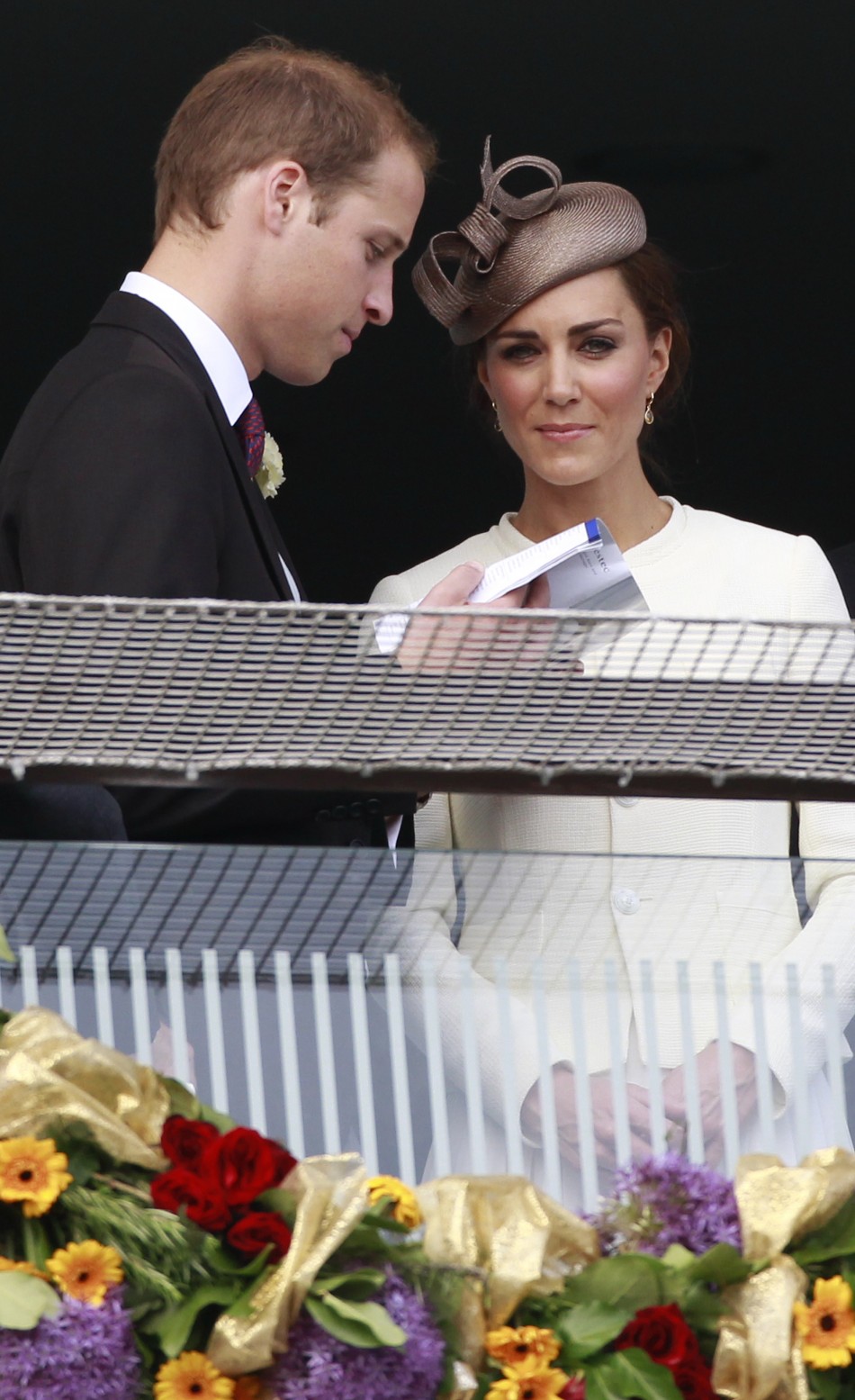 Britain039s Prince William and Catherine, Duchess of Cambridge, watch the racecourse after Queen Elizabeth039s horse Carlton House lost the Epsom Derby at Epsom Racecourse in southern England