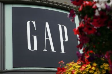 A basket of flowers hangs near Gap Inc&#039;s flagship retail store at the Powell Street cable car turn in San Francisco