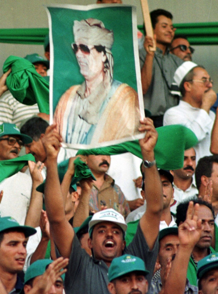 Posters of Libyan leader Muammar Gaddafi held by his supporters Posters of Libyan leader Muammar Gaddafi held by his supporters