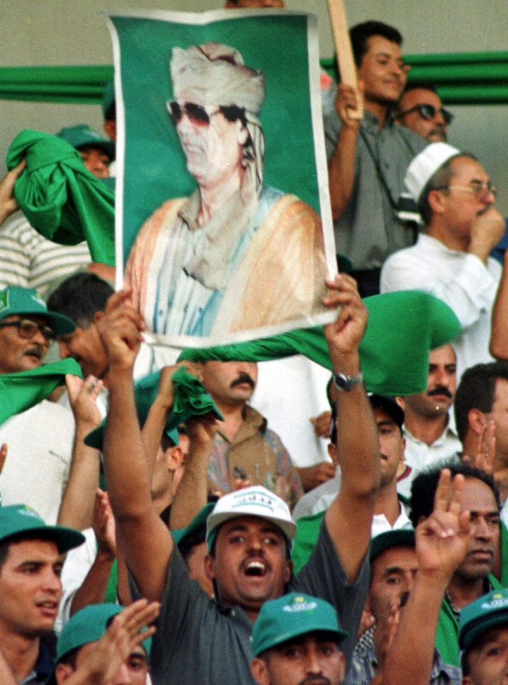 Posters of Libyan leader Muammar Gaddafi held by his supporters
