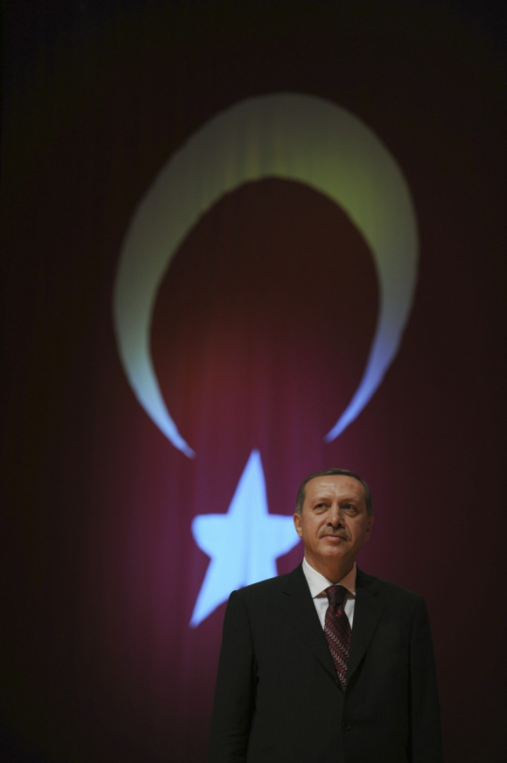 TurkisPrime Minister Recep Tayyip Erdogan standing in front of Turkey's national flag
