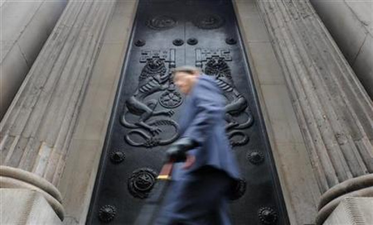 A man passes a doorway at the Bank of England in the City of London