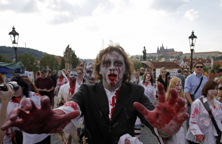 Enthusiasts dressed as zombies march across the medieval Charles Bridge during a Zombie Walk procession in Prague
