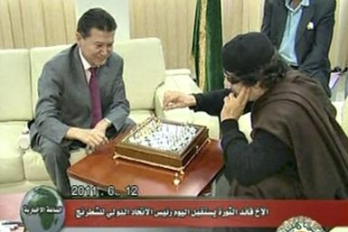 Libyan leader Gaddafi plays chess with Ilyumzhinov, the president of the international chess federation, in Tripoli in this still image taken from video broadcast on Libyan state television