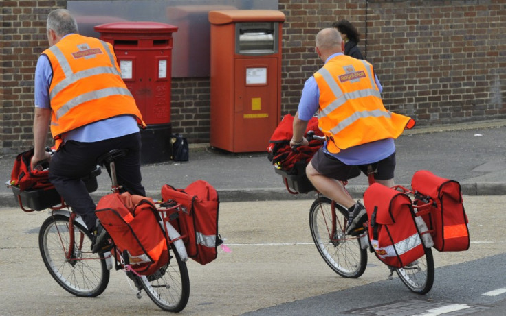 Postal workers return to a delivery office in west London