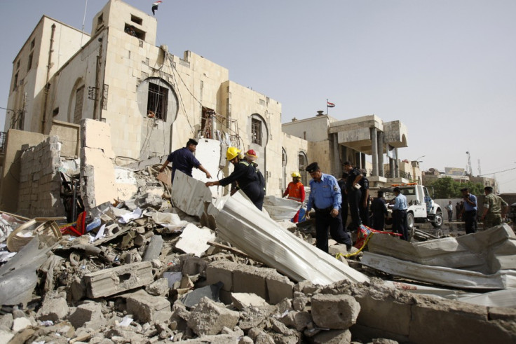 Security personnel and rescue workers gather at the site of a bomb attack in Basra