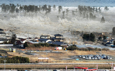 An aerial photo shows a residential area being hit by a tsunami in Natori, Miyagi prefecture An aerial photo shows a residential area being hit by a tsunami in Natori, Miyagi prefecture