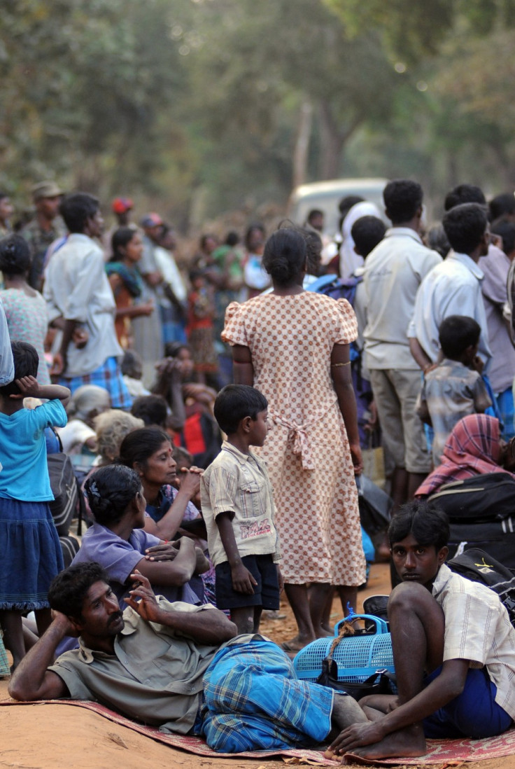 Ethnic Tamil civilians wait to go to a camp for internally displaced people