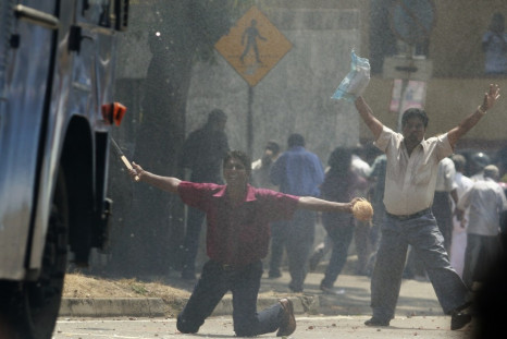 Supporters of former army commander General Sarath Fonseka try to block a water cannon truck during a protest against Fonseka's arrest in Colombo.