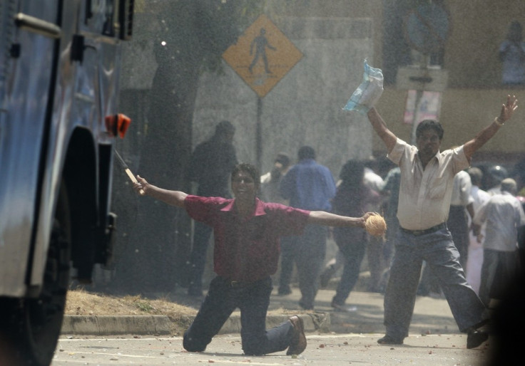 Supporters of former army commander General Sarath Fonseka try to block a water cannon truck during a protest against Fonseka&#039;s arrest in Colombo.
