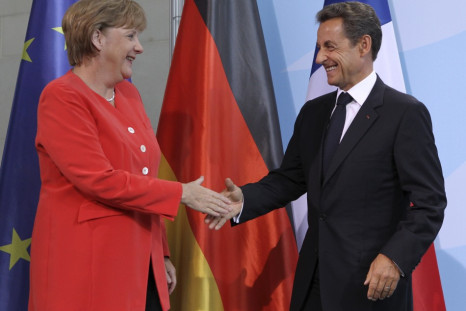 French President Sarkozy and German Chancellor Merkel shake hands after news conference at the Chancellery in Berlin