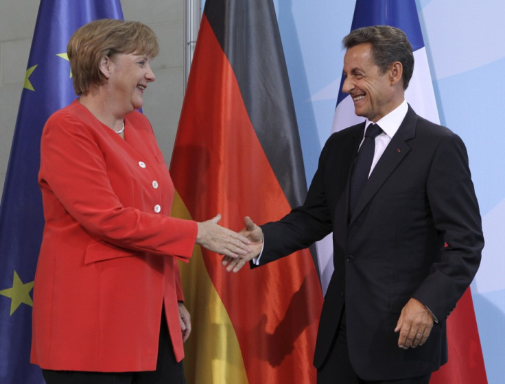 French President Sarkozy and German Chancellor Merkel shake hands after news conference at the Chancellery in Berlin