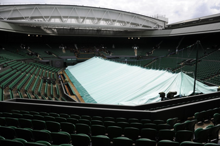 The covers are seen pulled across Centre Court during rainy weather on the day before the start of the 2011 Wimbledon tennis championships in London.