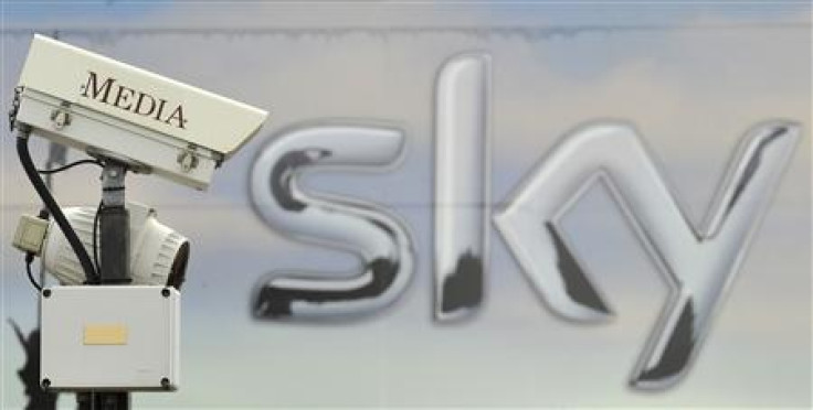 A CCTV camera points past a Sky logo in London