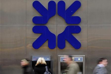 A woman uses an ATM at a Royal Bank of Scotland branch in the City of London