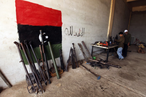 Rebel army officers fix weapons taken from forces loyal to Libyan leader Muammar Gaddafi at a workshop in Benghazi