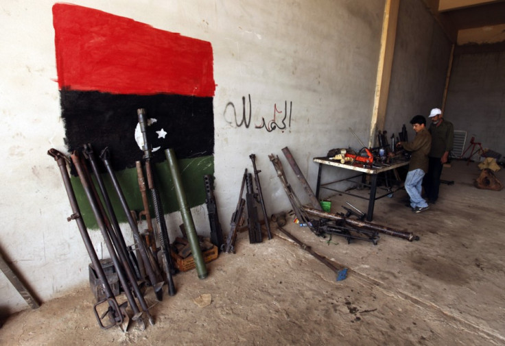 Rebel army officers fix weapons taken from forces loyal to Libyan leader Muammar Gaddafi at a workshop in Benghazi