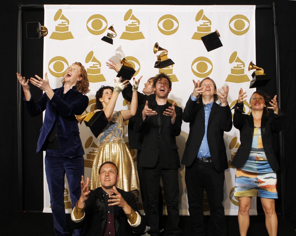 Rock group Arcade Fire throws their awards in the air at the 53rd annual Grammy Awards in Los Angeles