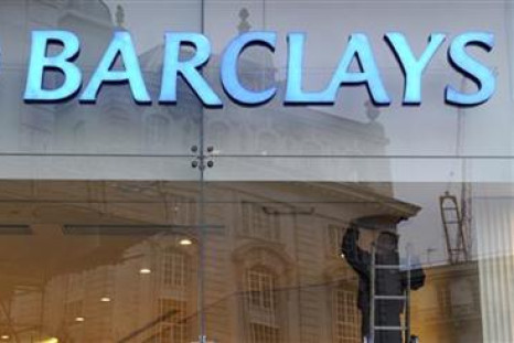 A worker carries out maintenance in a branch of Barclays bank in London
