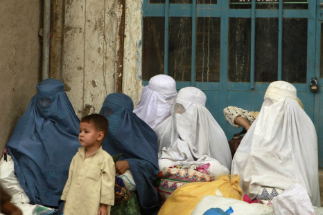 Afghan women wait for transportation in Kabul
