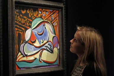 A employee poses with Pablo Picasso&#039;s &quot;Jeune fille endormie&quot; at Christie&#039;s auction house in London