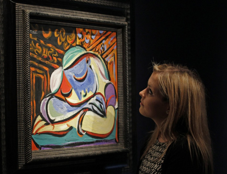 A employee poses with Pablo Picasso's "Jeune fille endormie" at Christie's auction house in London