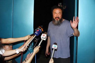 Dissident Chinese artist Ai Weiwei stands in the entrance of his studio after being released on bail in Beijing