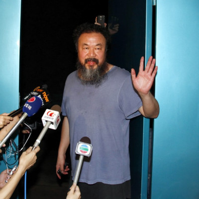 Dissident Chinese artist Ai Weiwei stands in the entrance of his studio after being released on bail in Beijing