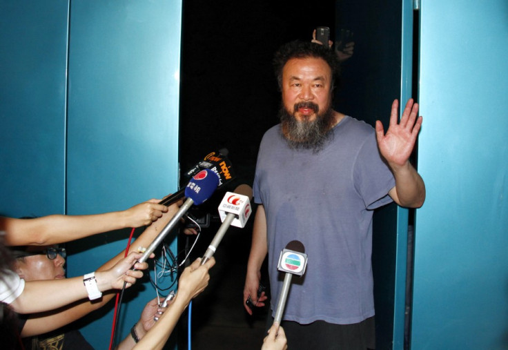 Dissident Chinese artist Ai Weiwei stands in the entrance of his studio after being released on bail in Beijing