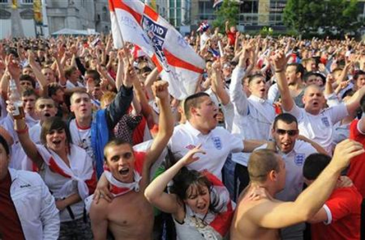 England fans watching on a big screen in Leeds react after a goal is scored during the World Cup soccer match between England and the U.S.