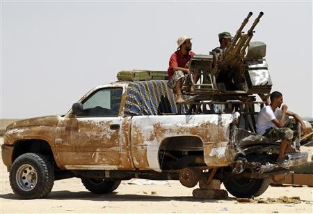 Rebel fighters man an anti-aircraft gun