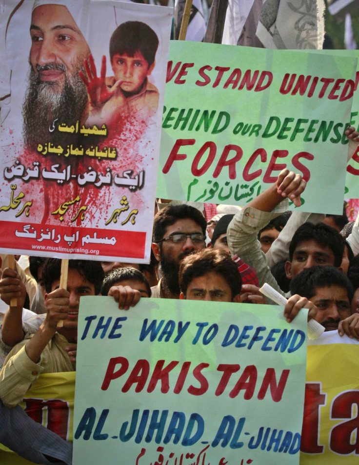 Supporters of the banned Islamic organization Jamaat-ud-Dawa hold placards during a rally in favour of al Qaeda leader Osama bin Laden in Lahore