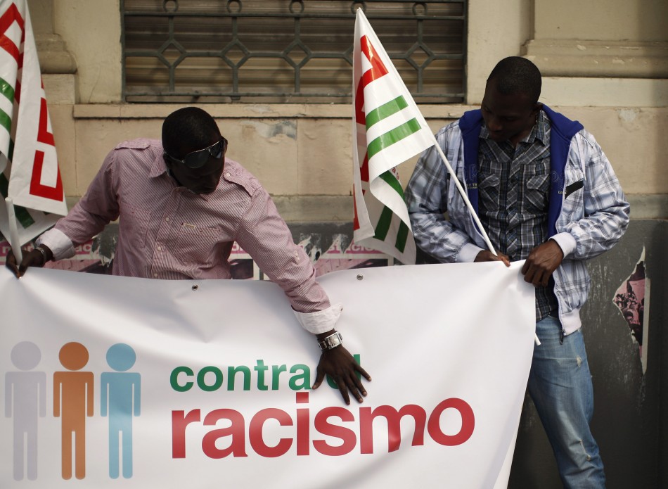 Demonstrators hold CCOO trade union flags while preparing to take part in a May Day rally in Malaga