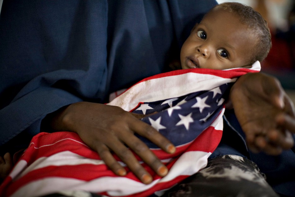 A malnourished Somali child is wrapped in an American quotStars and Stripesquot cloth at a therapeutic feeding center at Dagahaley camp