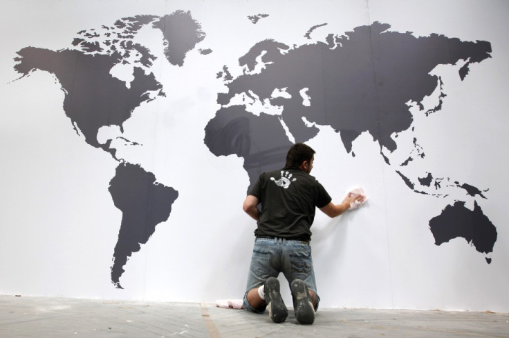 Worker fixes map of the World during final preparations at IAA commercial vehicles trade fair in Hanover