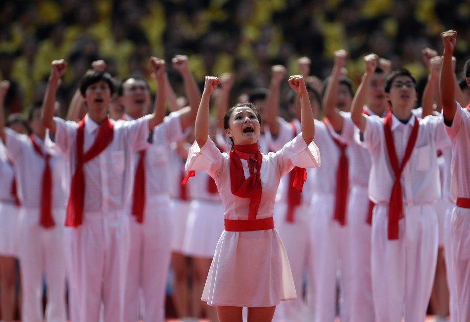 Students perform during the opening ceremony of a revolutionary song singing concert in Chongqing municipality